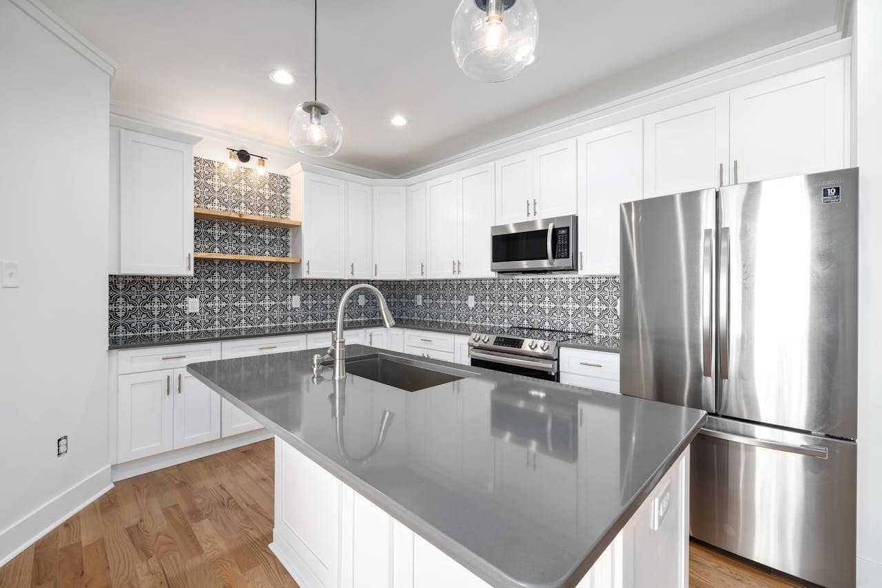 Sleek modern kitchen featuring a spacious island and stainless steel appliances, perfect for culinary enthusiasts.
